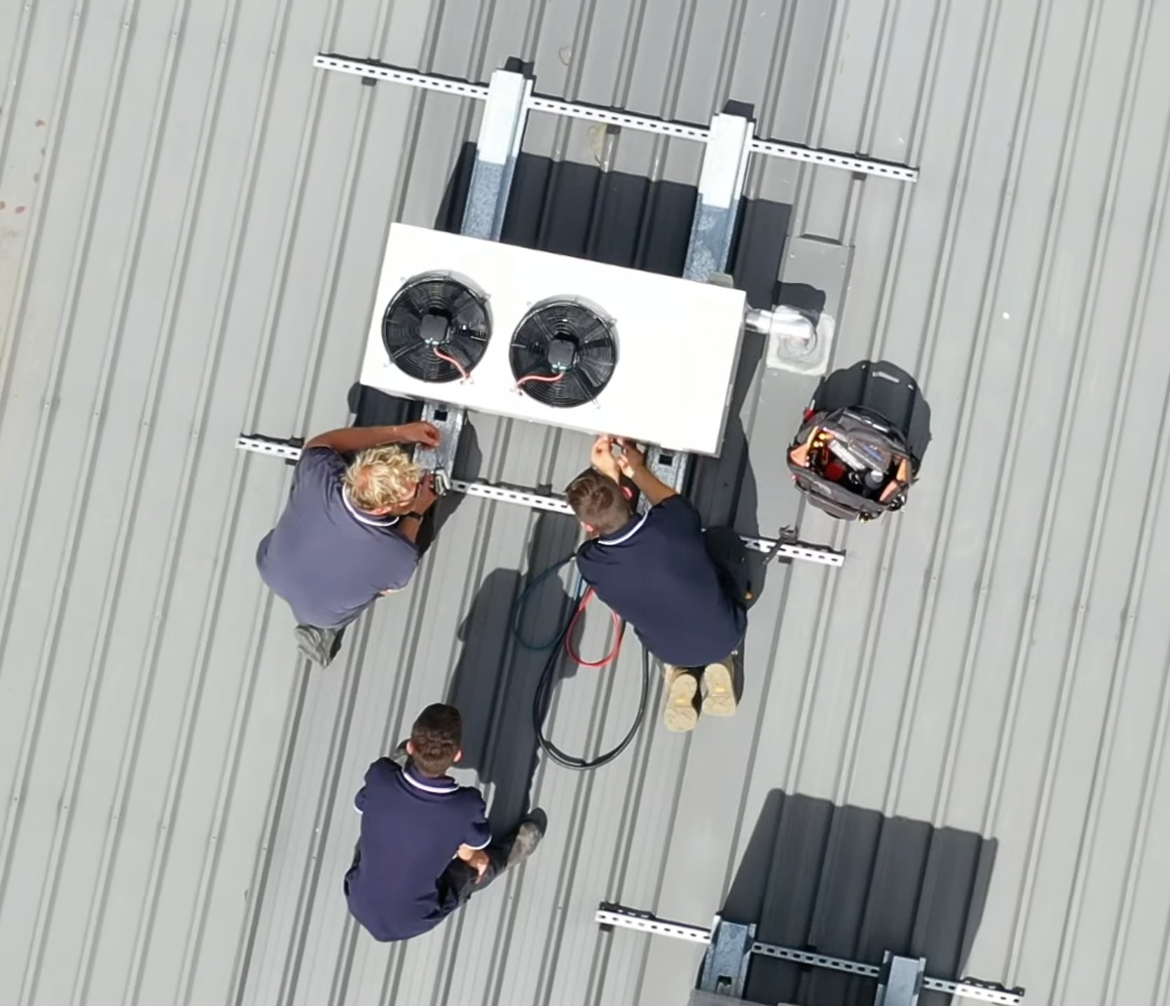 Overhead view of SETPOINT technicians installing a condenser with EC fans