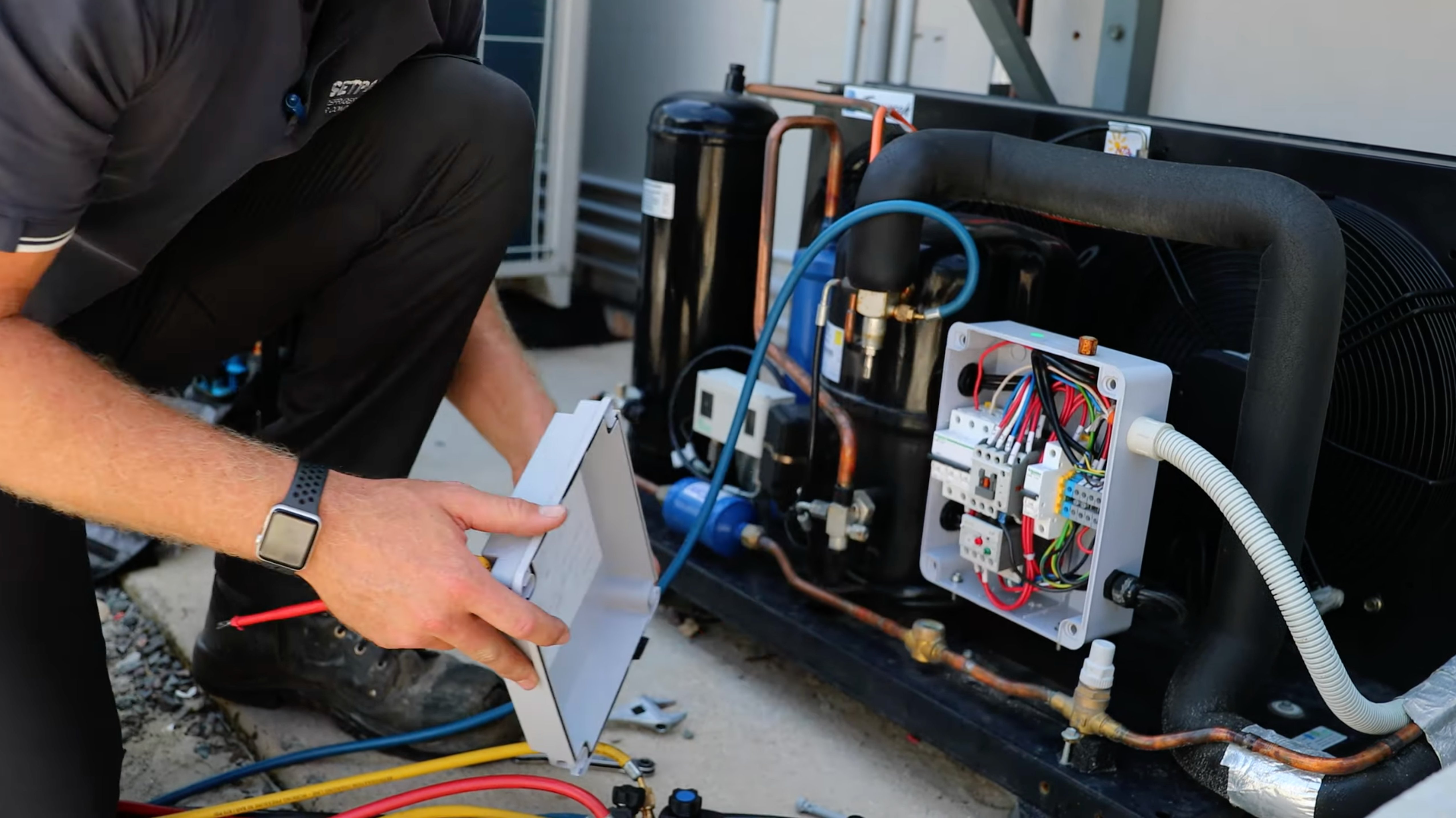 SETPOINT technician diagnosing a refrigeration condensing unit and control box