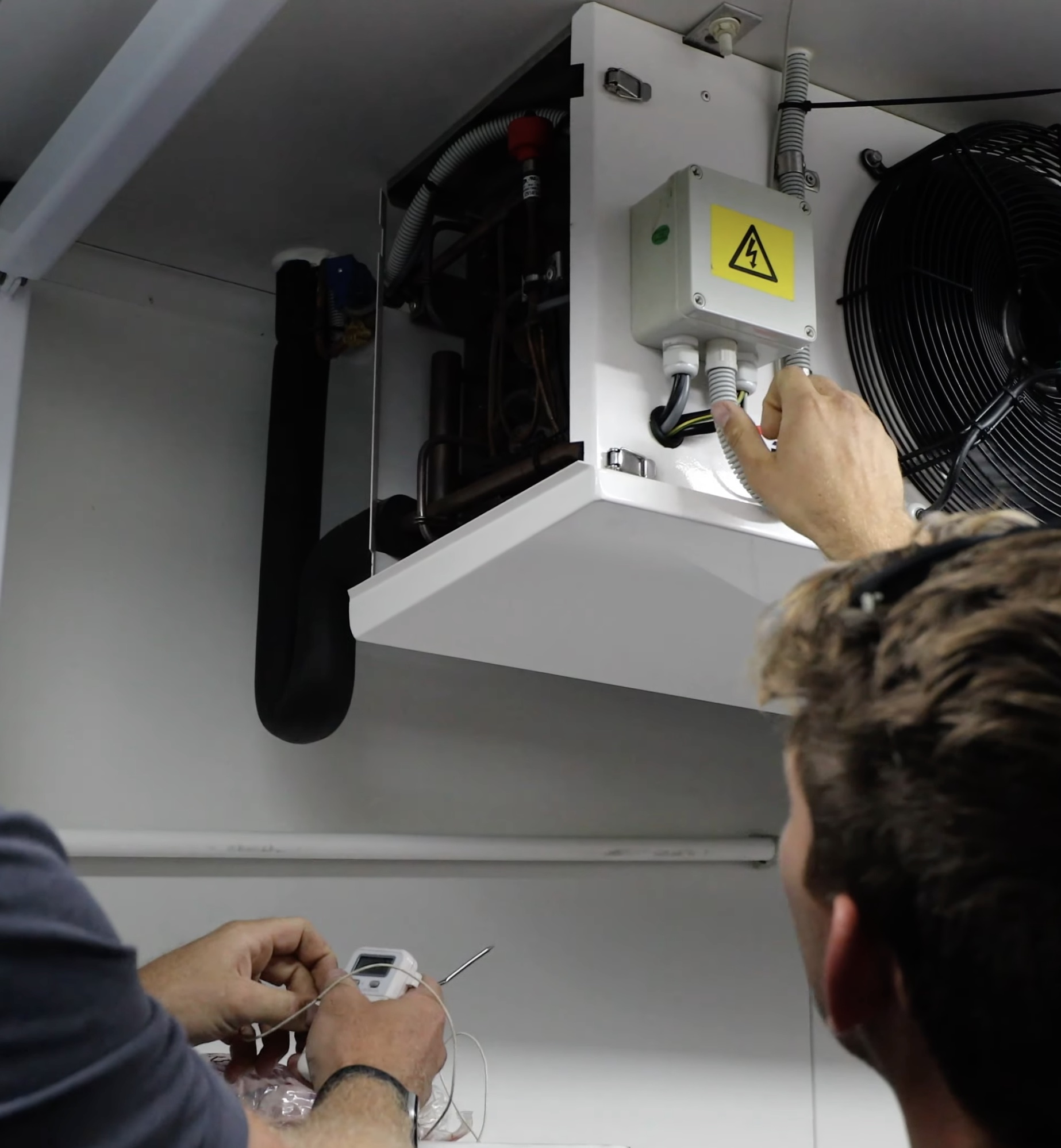 A SETPOINT technician servicing a coldroom evaporator unit