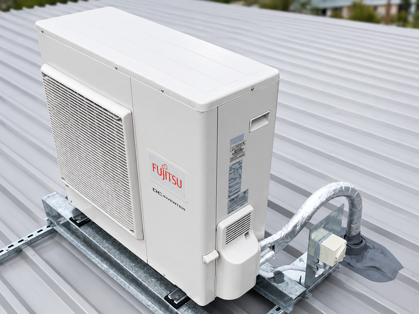 A Fujitsu reverse-cycle outdoor unit installed on a roof mount by SETPOINT