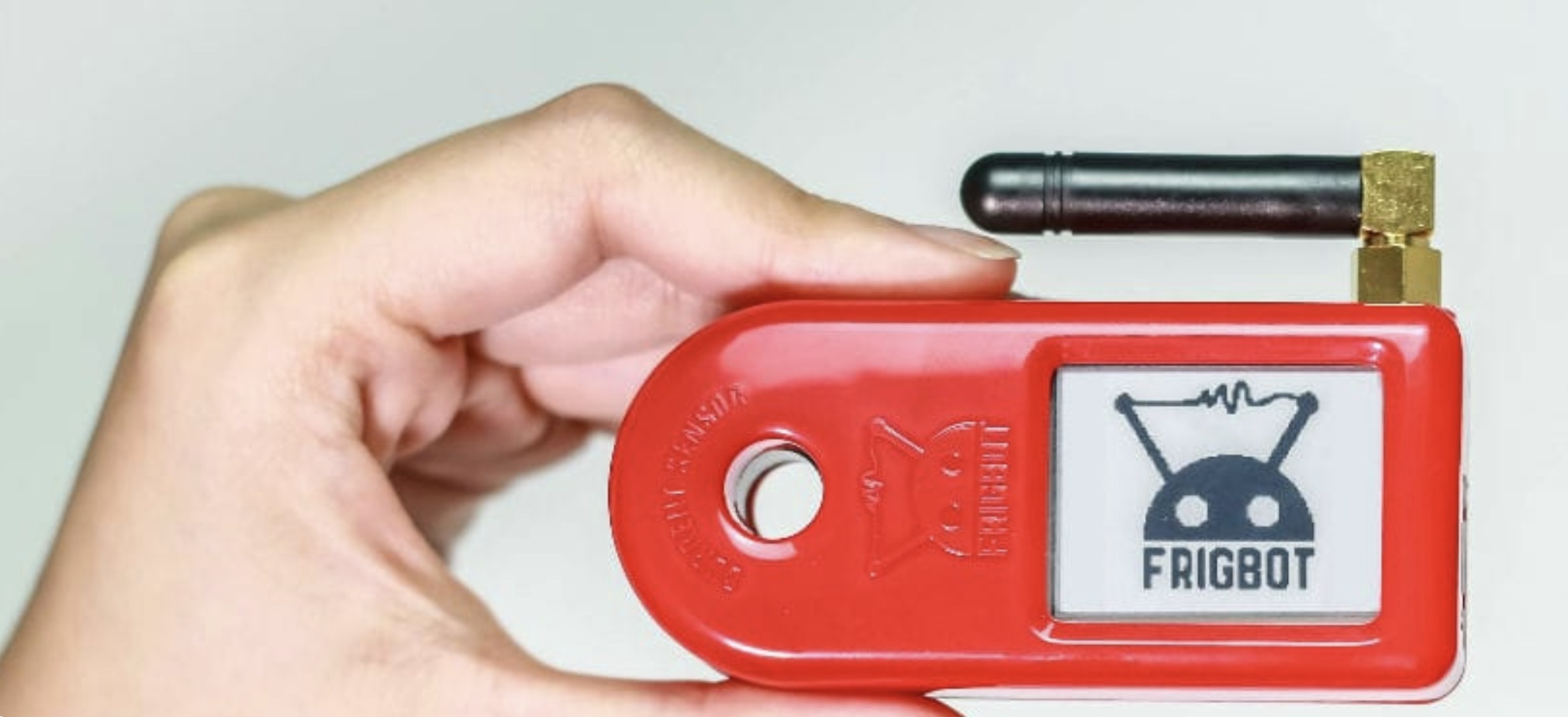 A Frigbot wireless temperature-monitoring sensor held in hand