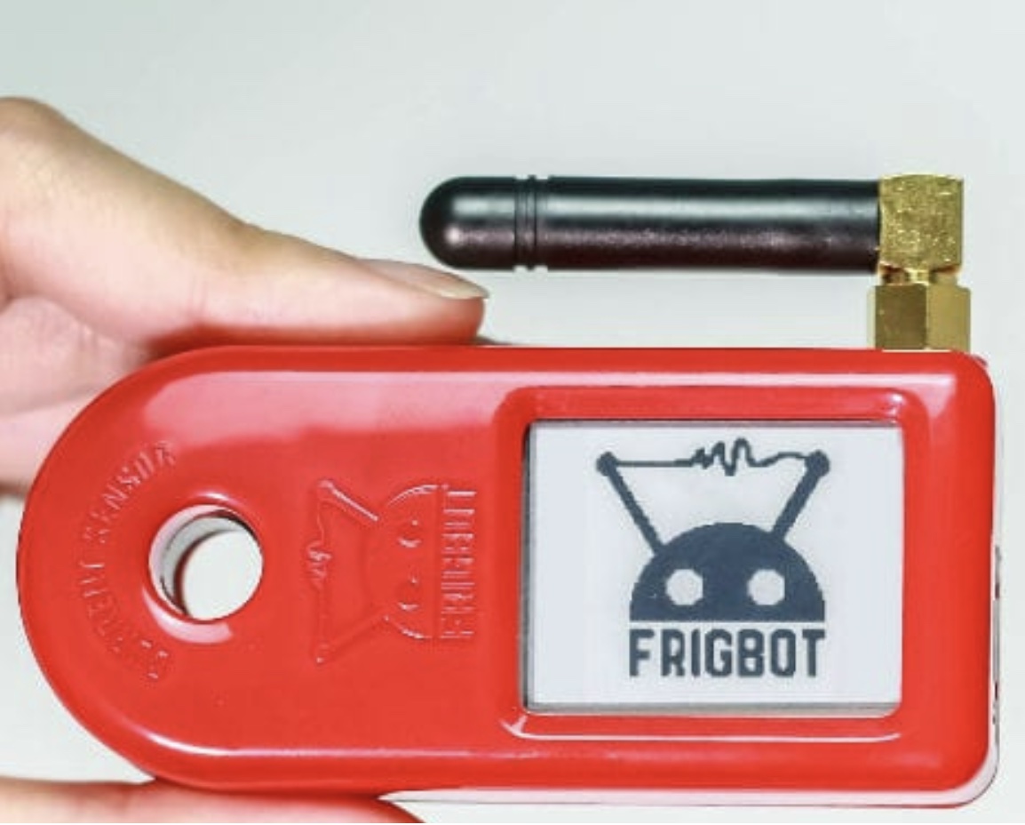 A Frigbot wireless temperature-monitoring sensor held in hand