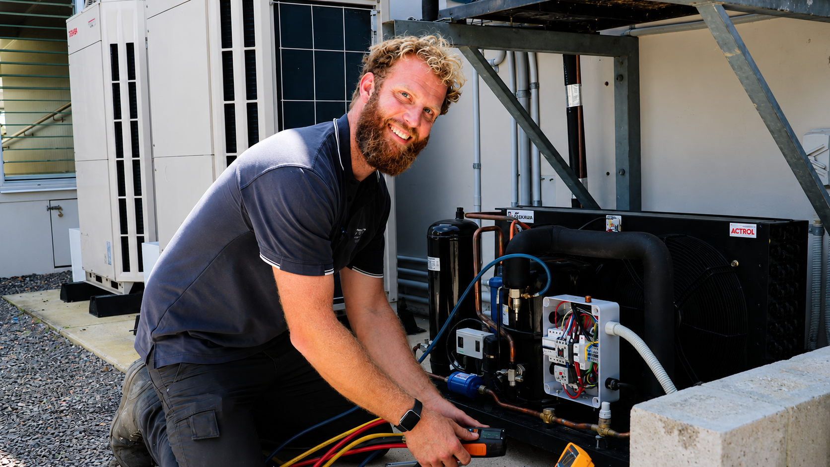 A SETPOINT technician working on a refrigeration condensing unit and electrical controls