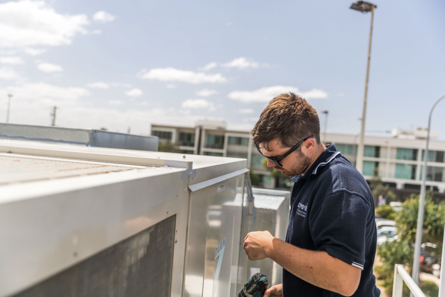 SETPOINT technician servicing a rooftop air conditioning unit