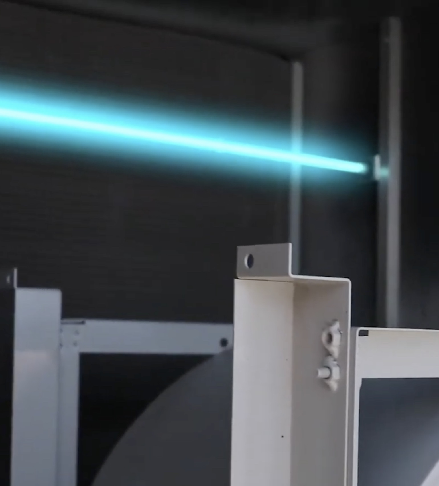 A UVC Emitter tube glowing inside an air handling unit